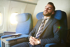 sleeping business man on plane